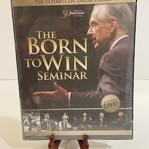 May include: Sealed DVD case for "The Born to Win Seminar" by Zig Ziglar. The cover features a man in a suit, with gold lettering and the text "Recorded Live!" The packaging is clear plastic.