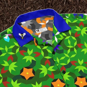 May include: A green, blue, orange and red patterned button-up shirt with a blue collar. The collar has a bee design and the text "Danger Dog Design" is visible inside the collar.