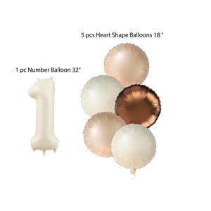 May include: A set of 6 balloons for a first birthday party. The set includes a large number 1 balloon, 32 inches in size, and 5 heart-shaped balloons, 18 inches in size. The balloons are in shades of beige and brown.
