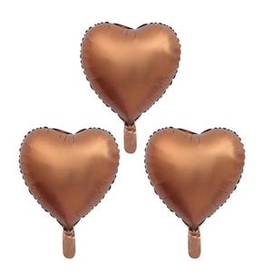 May include: Three copper-colored heart-shaped balloons. The balloons are inflated and ready to be used for a party or celebration.