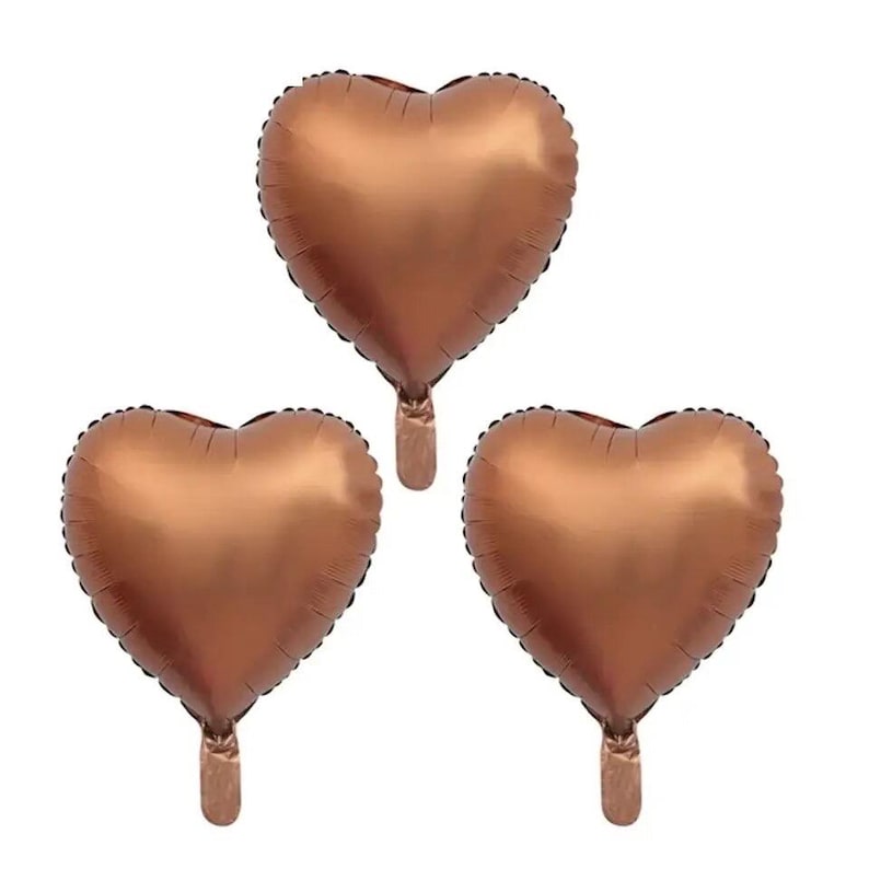 May include: Three copper-colored heart-shaped balloons. The balloons are inflated and ready to be used for a party or celebration.