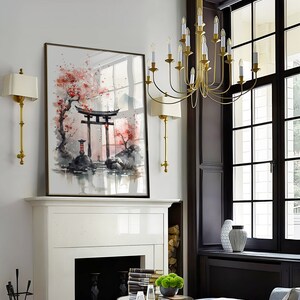 May include: A watercolor painting of a Japanese garden scene with a red torii gate, cherry blossoms, and a mountain in the background. The painting is framed in a simple black frame and hangs above a white fireplace.