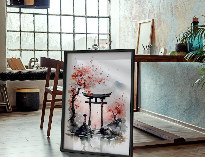 May include: A framed watercolor painting of a traditional Japanese gate, or torii, with cherry blossoms and a mountain in the background. The painting is in a black frame and is hanging on a wall.