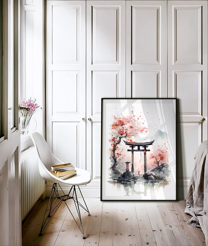 May include: A framed watercolor painting of a Japanese garden scene with a red torii gate, cherry blossoms, and a pond. The painting is in a black frame and is hanging on a white wall.