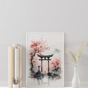 May include: A framed watercolor painting of a traditional Japanese torii gate with cherry blossoms and a mountain in the background. The painting is in a white frame and is hanging on a white wall.