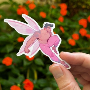 May include: A pink fairy sticker with a male figure wearing pink pants and a pair of wings. The figure has brown hair and is flying.