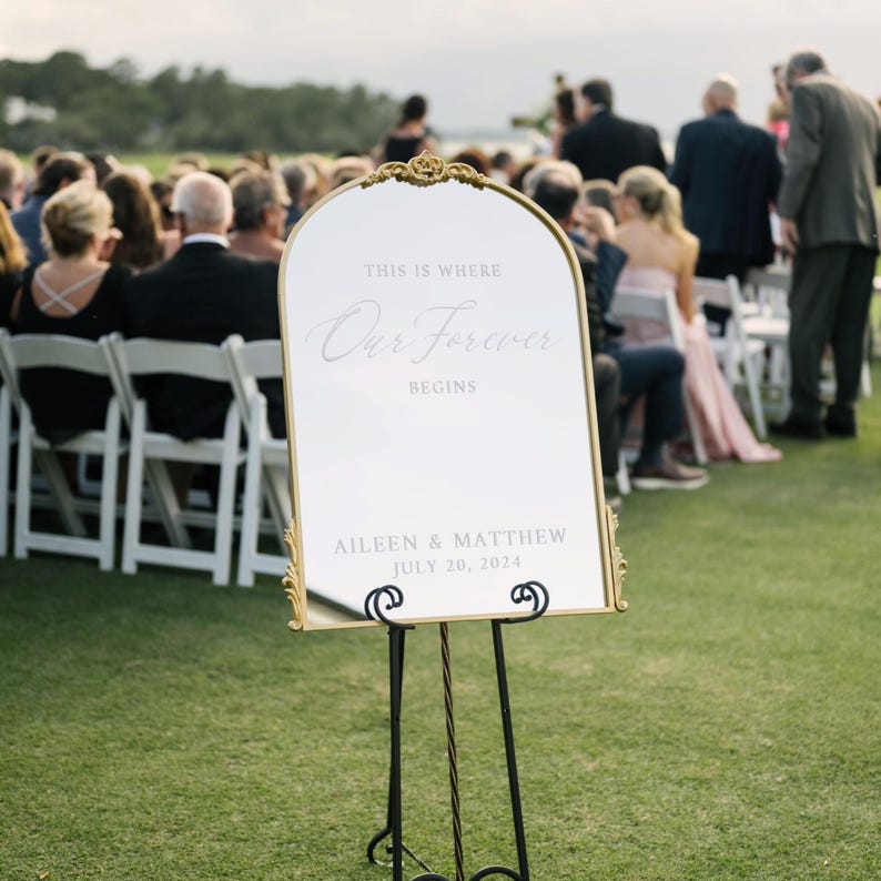Stylish gold arch and flourish mirror displaying a personalized vinyl scripted welcome sign, adding a touch of sophistication to your wedding or engagement celebration personalized vinyl scripted welcome sign perfect for elegant engagement events