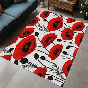 May include: A rectangular area rug featuring a repeating pattern of large red poppy flowers with black centers and stems against a white background. The rug has a textured appearance and is suitable for a living room or bedroom.