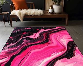 Op de afbeelding: Abstract vloerkleed met roze en zwarte draaiende patronen. Het kleed heeft een modern, eigentijds ontwerp.