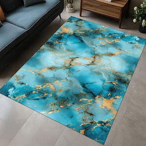 May include: Abstract area rug with a blue and gold marble pattern. The rug has a light blue background with gold veins and swirls.