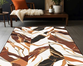 May include: Abstract area rug with a white background and brown, black, and gold marbling. The rug has a geometric pattern with a modern design.