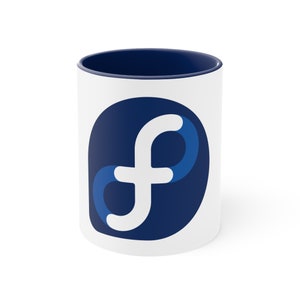 May include: White ceramic mug with a blue rim and a blue and white stylized "F" logo.