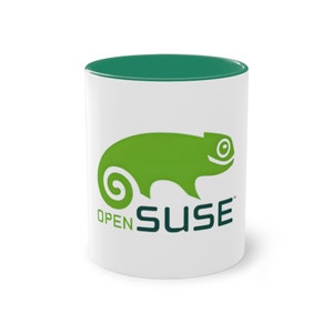 Può includere: Tazza in ceramica bianca con bordo verde e un logo di camaleonte verde con il testo "openSUSE" sul davanti.
