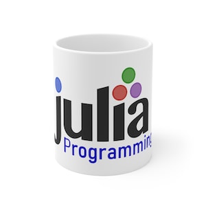 May include: White ceramic mug with the word "Julia" in black, and "Programming" in blue. The mug features colorful dots in green, red, and purple. A blue dot is also present. The mug is a standard 11 oz size.