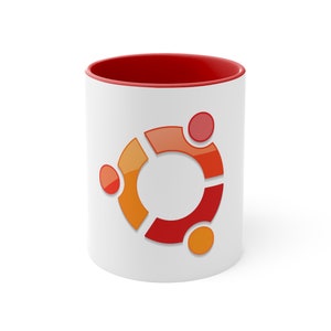 Könnte beinhalten: Weiße Keramiktasse mit rotem Rand und einem roten, orangen und gelben Logo des Linux-Betriebssystems.