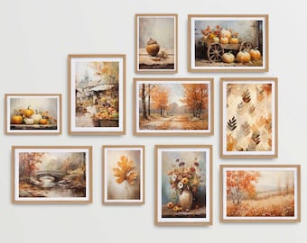 May include: A collection of nine framed fall-themed prints, including pumpkins, autumn leaves, and a country scene. The prints are arranged in a grid pattern on a white wall.