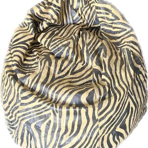 May include: A large, brown and black zebra-print bean bag chair. The chair is made of a soft, plush fabric and is perfect for relaxing.