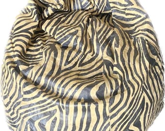 May include: A large, brown and black zebra-print bean bag chair. The chair is made of a soft, plush fabric and is perfect for relaxing.