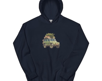 May include: Navy blue hooded sweatshirt featuring a graphic of a green off-road vehicle carrying a Christmas tree on its roof. The vehicle has a vintage aesthetic. The sweatshirt has a kangaroo pocket and a drawstring hood.