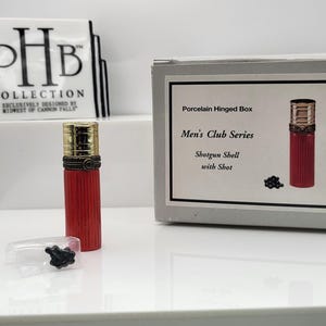 Shotgun shell porcelain hinged trinket box with buckshot trinket. Made by Midwest of Cannon Falls.