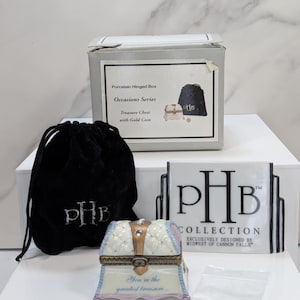 May include: A set of three ceramic mugs with a speckled, matte finish. The mugs are in shades of cream, light gray, and dark gray. Each mug has a simple, minimalist design, perfect for coffee or tea.