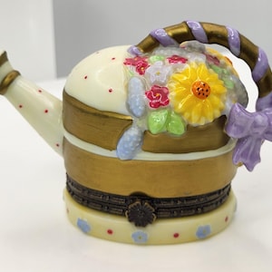Watering can with flowers porcelain hinged box with hand shovel trinket.