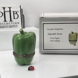 Green pepper porcelain hinged box with ladybug porcelain trinket made by midwest of cannon falls.