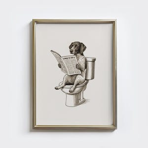 May include: Framed print of a dog on the toilet, reading a newspaper. The dog is a German Shorthaired Pointer, with a brown and white coat. The newspaper reads "FLOWERS OLD SEED CO."