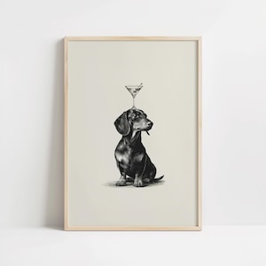 May include: Monochrome illustration of a dachshund with a martini glass balanced on its head. The dog is depicted in a seated position, with a dark coat and a sideways gaze. The martini glass contains a green olive.