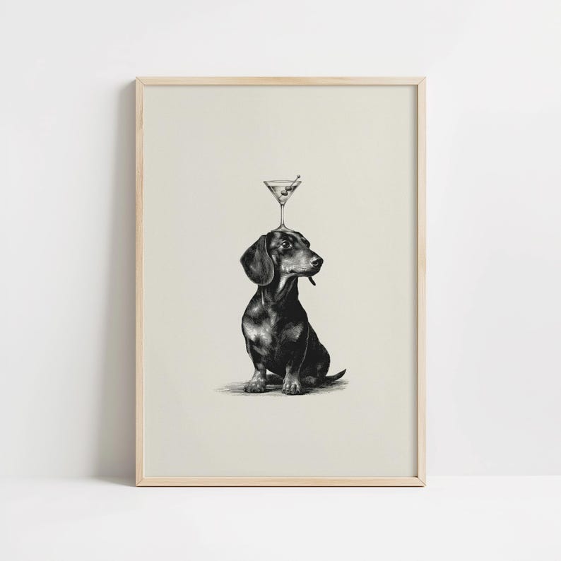 May include: Monochrome illustration of a dachshund with a martini glass balanced on its head. The dog is depicted in a seated position, with a dark coat and a sideways gaze. The martini glass contains a green olive.