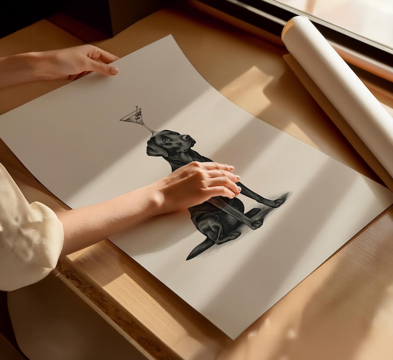 May include: A black and white illustration of a black Labrador Retriever balancing a martini glass on its nose. The dog is sitting, with its front paws extended. The artwork is on a large, off-white paper.