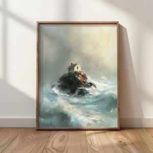May include: A framed art print depicts a small white house with a red roof perched on a rocky island in a stormy sea. The artwork features a wooden frame and a dramatic, painterly style with shades of blue, gray, and white.