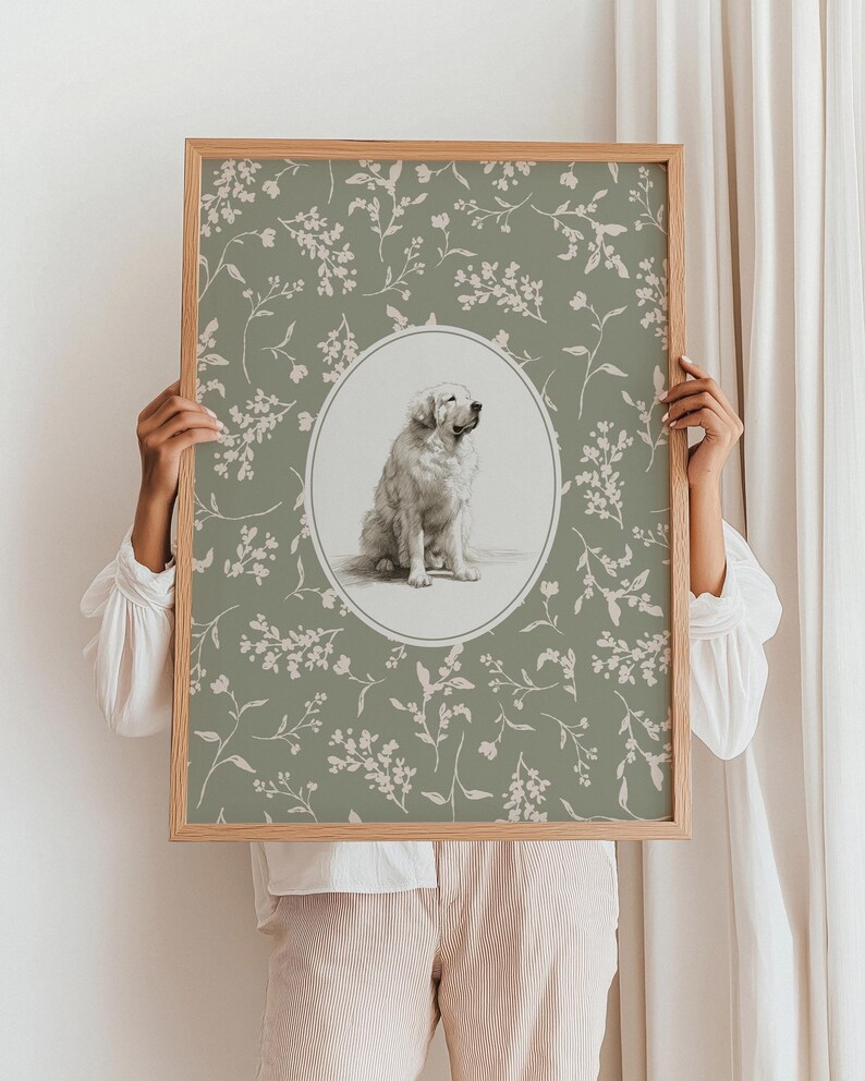 May include: A framed print with a seated dog illustration in an oval frame. The background is sage green with a floral pattern. The frame is made of light brown wood.