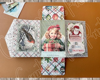 May include: A Christmas-themed paper craft with a plaid background. The craft features a girl holding a gift, a bird, and a Santa Claus figure. The text "Merry Christmas" is visible on the craft.