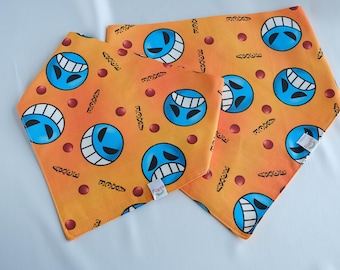 May include: Three orange bandana bibs with a blue smiling face pattern. The bandanas have the text "3387" and "AXCE" printed on them.