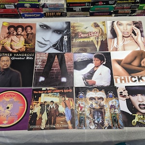 May include: A collection of 10 music albums, including artists like Luther Vandross, Michael Jackson, Jane Child, and TLC. The albums are displayed on a white surface.