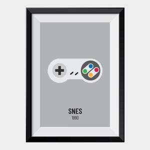 May include: Framed print with a minimalist illustration of a SNES controller. The controller is white with a black cross, coloured buttons, and a grey background. The word "SNES" and the year "1990" are printed below the controller.