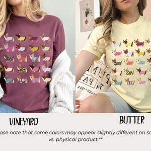 May include: Two t-shirts, one vineyard-colored and one butter-colored, each featuring a repeating pattern of dachshunds wearing various outfits. The vineyard shirt is long-sleeved, while the butter shirt is short-sleeved. The text "VINEYARD" and "BUTTER" are below the shirts.