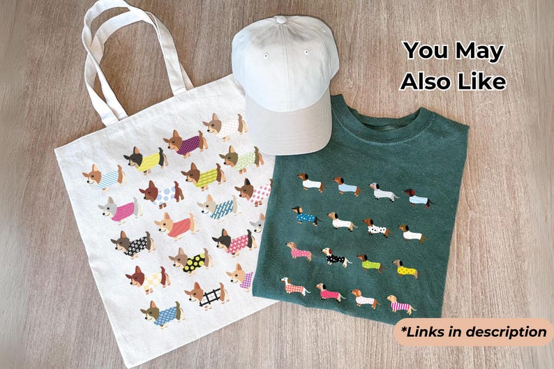 May include: A white tote bag, a light gray baseball cap, and a green t-shirt are displayed. The tote bag and t-shirt feature a repeating pattern of dachshunds wearing various outfits. The text "You May Also Like" and "*Links in description" are also visible.