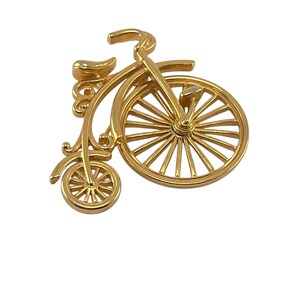 Vintage goudkleurige driewieler fietsbroche pin wiel draait