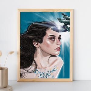 May include: A framed art print featuring a portrait of a woman with long dark hair, looking to the side. A hand with sharp claws is reaching towards her head, holding a reflective disc. The words "IMAGINAL DISK" are tattooed on her chest.