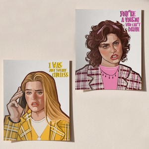 May include: Two art prints featuring illustrations of characters from the movie "Clueless." One print shows a woman on the phone with the text "I WAS JUST TOTALLY CLUELESS." The other print depicts a woman with the text "YOU'RE A VIRGIN WHO CAN'T DRIVE."
