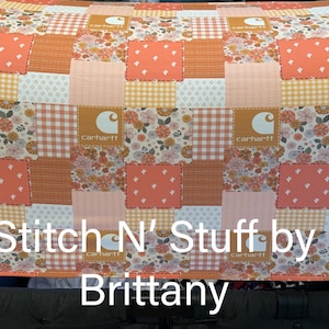 May include: A patchwork fabric cover in shades of peach, orange, and cream, featuring floral, gingham, and solid square patterns. The cover has the Carhartt logo on some squares and the text "Stitch N' Stuff by Brittany".