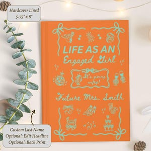 May include: An orange hardcover lined journal, 14.6 cm x 20.3 cm, with the text "LIFE AS AN Engaged Girl" in teal. The cover includes teal illustrations and the text "Future Mrs. Smith".