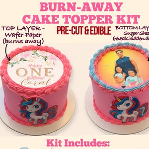 May include: A pink cake topper kit with the text "BURN-AWAY CAKE TOPPER KIT". The kit includes a wafer paper sheet and a sugar/icing sheet. The cakes are decorated with a unicorn and the text "Happy ONE Birthday Coral".