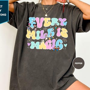 a woman wearing a mickey mouse tshirt
