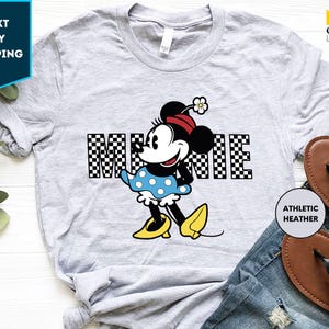 a mickey mouse shirt with a checkered background