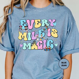 a woman wearing a t - shirt that says every mile is magic