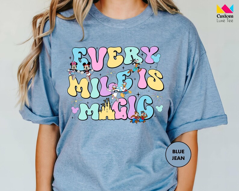 a woman wearing a t - shirt that says every mile is magic