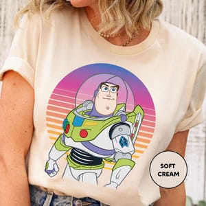 a woman wearing a t - shirt with a cartoon character on it